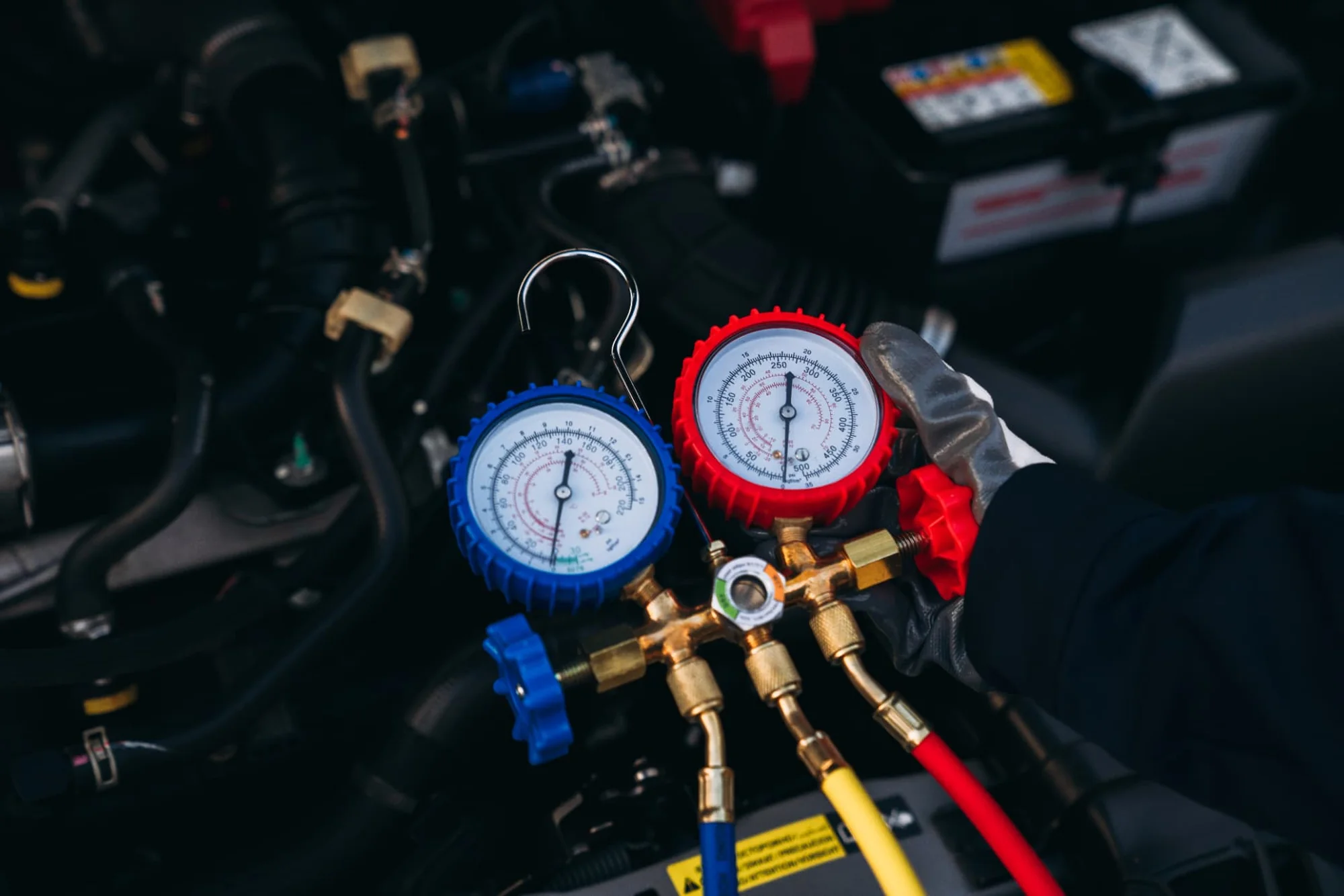 Pressure gauges checking a car air-conditioning system