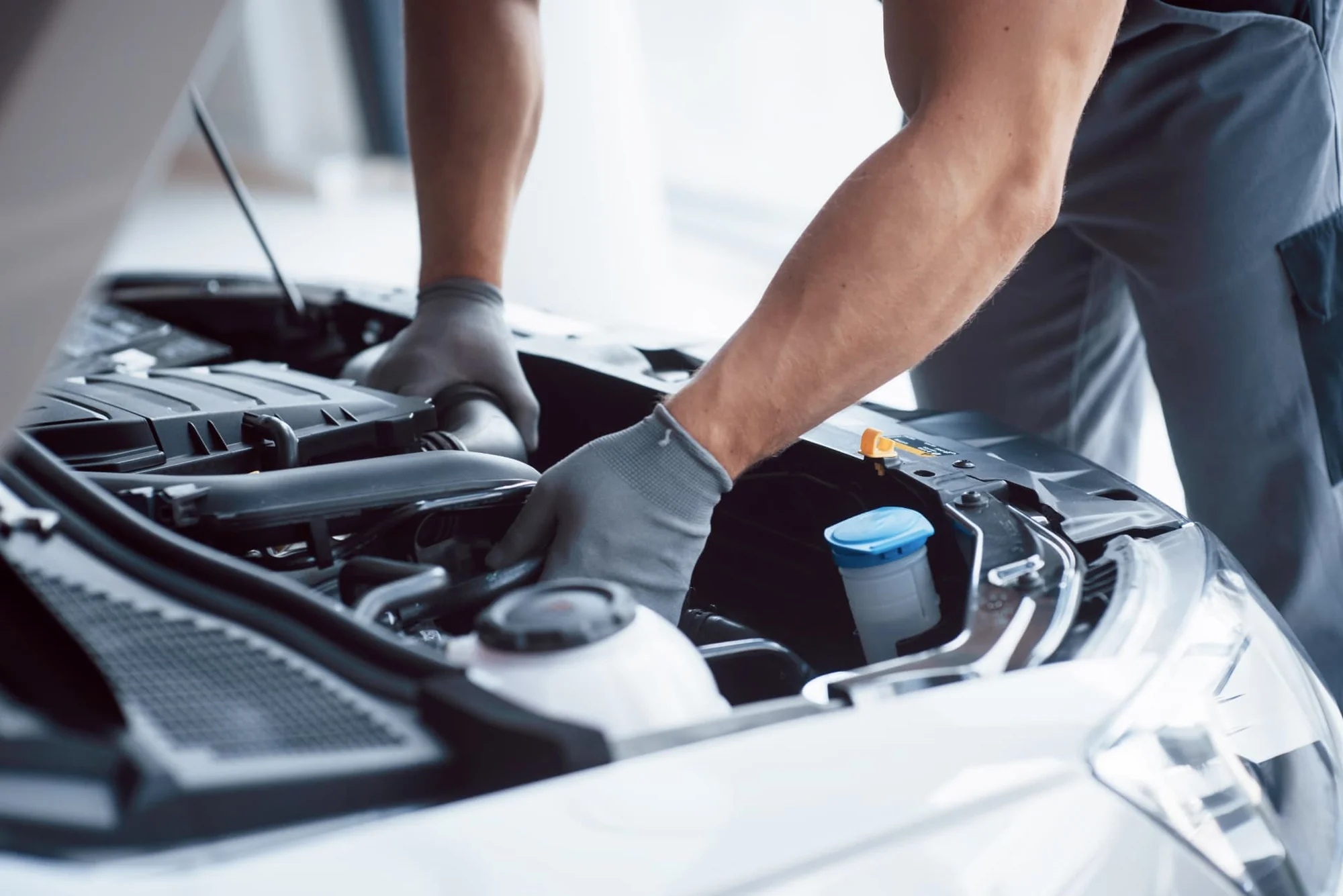 Mechanic inspecting a car engine bay