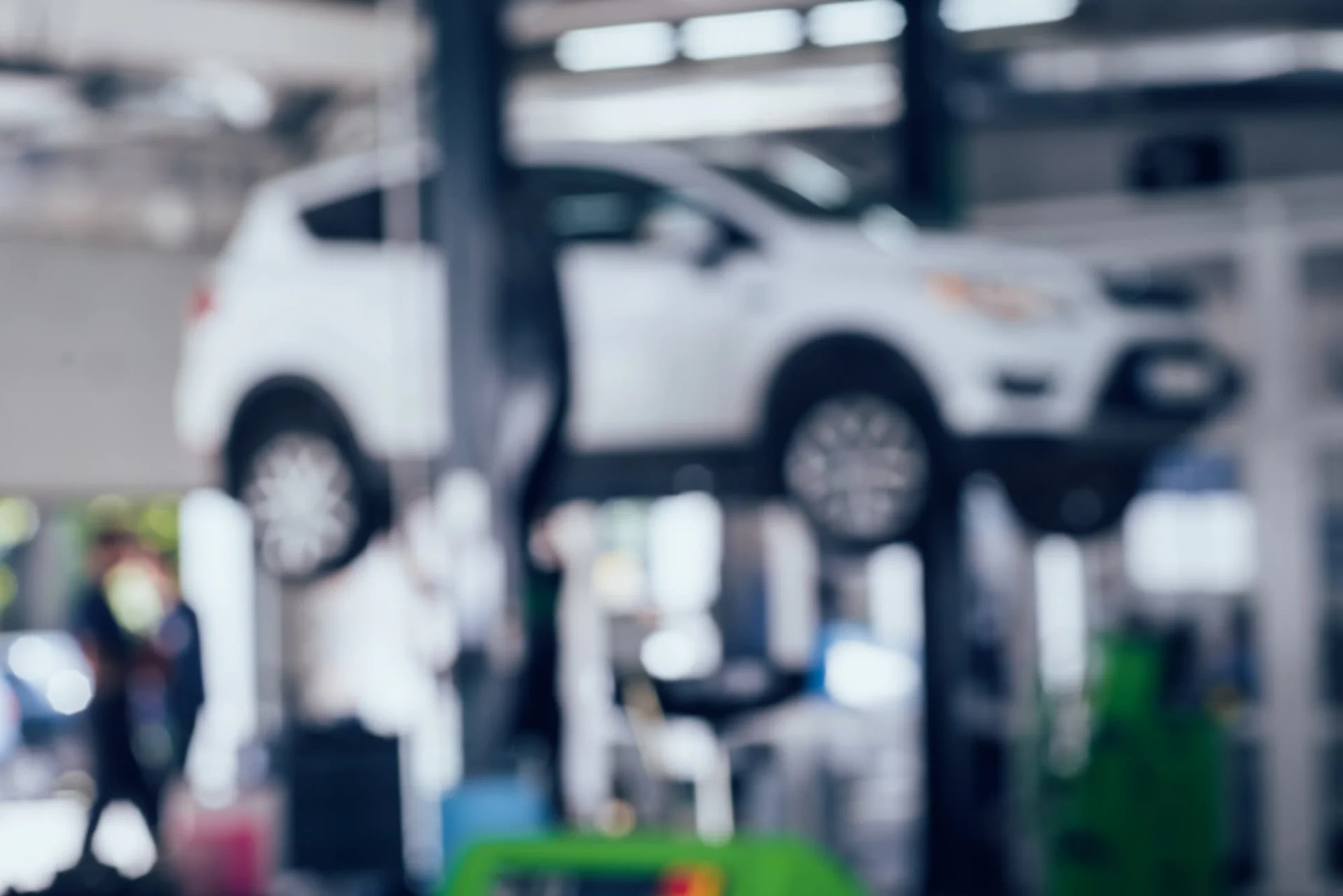 Car raised on a lift in an automotive workshop