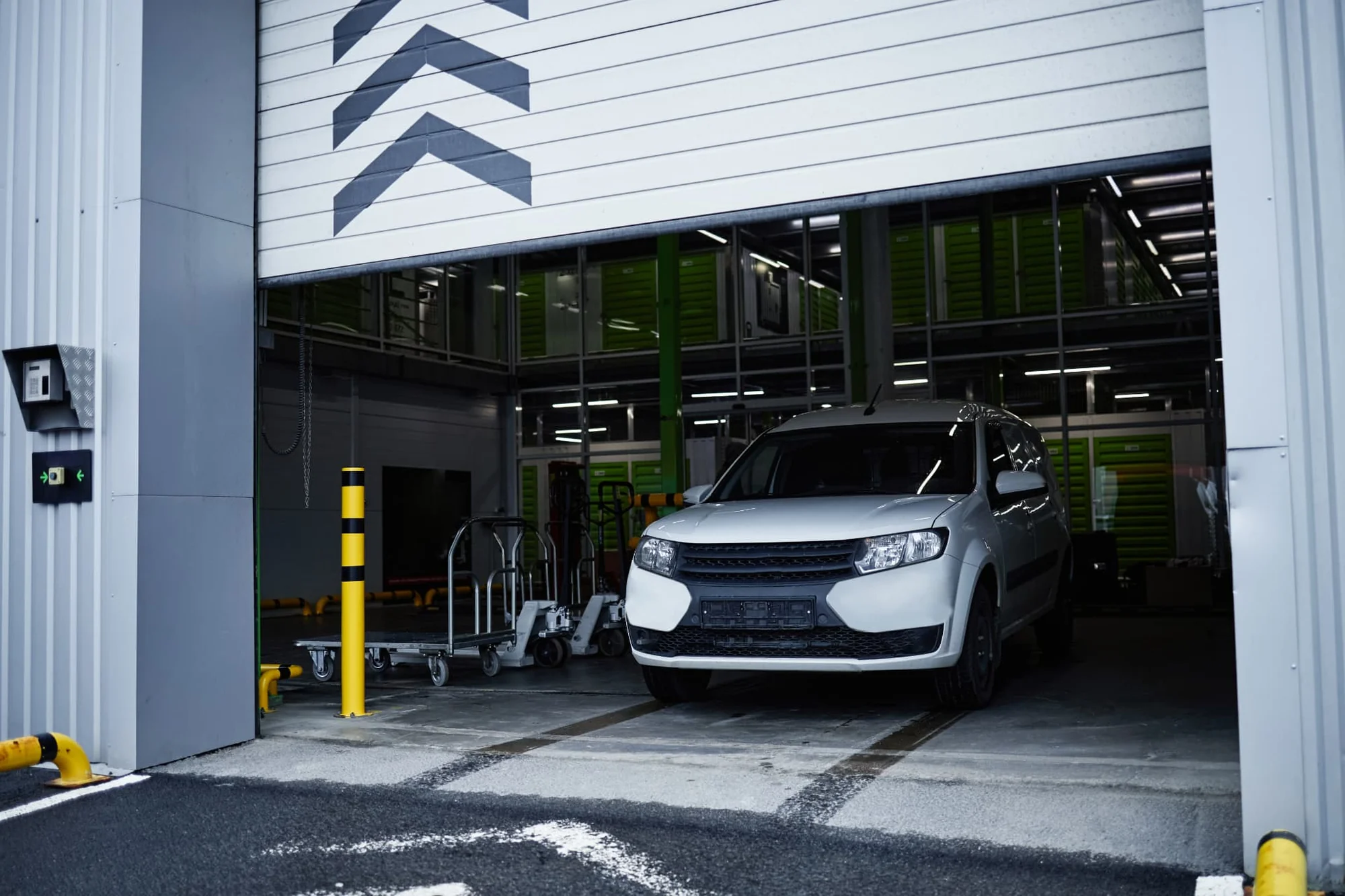 White vehicle in an open workshop bay